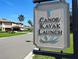 Community Canoe/Kayak launch sign with lush landscaping and picturesque homes in the background at 1264 Riverscape St # B, Bradenton, FL 34208