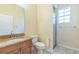 Bathroom featuring granite vanity, toilet, and tiled walk-in shower at 1330 16Th St, Sarasota, FL 34236
