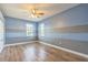 Bedroom with laminate flooring, overhead fan, and horizontally painted walls at 1330 16Th St, Sarasota, FL 34236