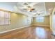 Spacious bedroom with two windows featuring wood blinds, wood floors, and two ceiling fans at 1330 16Th St, Sarasota, FL 34236