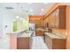 Open kitchen with granite countertops, wooden cabinets, and stainless-steel appliances at 1330 16Th St, Sarasota, FL 34236