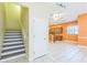 Open-concept living space with staircase, tile flooring, and a seamless transition to the kitchen at 1330 16Th St, Sarasota, FL 34236