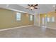 Spacious living room with ceiling fan, tray ceiling, and access to entryway at 1330 16Th St, Sarasota, FL 34236