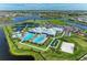 Aerial view featuring community center with pools, tennis courts, bocce ball, and landscaping at 15507 Sunny Day Dr, Bradenton, FL 34211