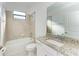 Bright bathroom featuring a shower-tub combo, large mirror, and granite countertop vanity at 15507 Sunny Day Dr, Bradenton, FL 34211