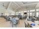 Dining room with a full bar, large windows, and wood-look tile flooring at 15507 Sunny Day Dr, Bradenton, FL 34211