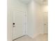 Clean entryway with white door and neutral tile flooring at 15507 Sunny Day Dr, Bradenton, FL 34211