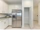 Bright kitchen with stainless steel appliances, white cabinets, granite counters, and an open pantry at 15507 Sunny Day Dr, Bradenton, FL 34211