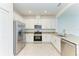 Bright kitchen with stainless steel appliances, granite countertops, and white cabinets at 15507 Sunny Day Dr, Bradenton, FL 34211