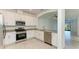 Bright kitchen with white cabinets, stainless steel appliances, and granite countertops at 15507 Sunny Day Dr, Bradenton, FL 34211