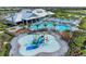 Aerial shot showcasing pools, amenities, and lush landscaping around community center at 15507 Sunny Day Dr, Bradenton, FL 34211