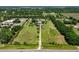 Expansive aerial view of a large lot with green fields, mature trees, and a home nestled in the center at 16305 E State Road 64, Bradenton, FL 34212