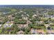 An aerial view of a neighborhood surrounded by lush greenery and a tranquil pond at 1631 Madison Ave, North Port, FL 34286
