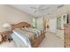 Bright bedroom with a ceiling fan, wood furniture and an ensuite bathroom door at 1631 Madison Ave, North Port, FL 34286