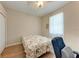 Bedroom featuring wood floors, a ceiling fan and a double bed with a floral comforter at 1631 Madison Ave, North Port, FL 34286