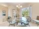 Bright dining room featuring a glass table set and a display cabinet by a window at 1631 Madison Ave, North Port, FL 34286