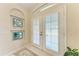 Bright foyer featuring double doors, decorative mirrors, and tile flooring, creating an inviting entrance at 1631 Madison Ave, North Port, FL 34286