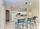 Bright kitchen features a breakfast bar with seating and white appliances and cabinetry at 1631 Madison Ave, North Port, FL 34286
