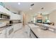 Bright kitchen with bar-style seating, white cabinets, and stainless steel appliances at 1631 Madison Ave, North Port, FL 34286