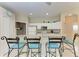 Well-lit kitchen boasts a convenient breakfast bar and white appliances, ready for meal prep at 1631 Madison Ave, North Port, FL 34286