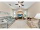 Comfortable living room with large windows, a ceiling fan, and a television for entertainment at 1631 Madison Ave, North Port, FL 34286