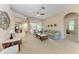Spacious living room with plush seating, a ceiling fan, and ample natural light from sliding glass doors at 1631 Madison Ave, North Port, FL 34286