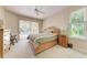 Main bedroom featuring a king bed and sliding door to screened outdoor pool area at 1631 Madison Ave, North Port, FL 34286