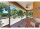 Screened patio featuring wicker furniture, offering a relaxing outdoor space with views at 1631 Madison Ave, North Port, FL 34286