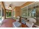 Covered patio with outdoor seating, perfect for enjoying the serene surroundings at 1631 Madison Ave, North Port, FL 34286
