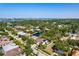 Aerial view showcasing a home with lush greenery and distant water views under a sunny sky at 1719 Kenilworth St, Sarasota, FL 34231
