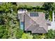 Aerial view showcasing the home's roof-top solar panels, backyard pool, and landscaping at 1719 Kenilworth St, Sarasota, FL 34231