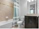 Bathroom with a tiled tub/shower, modern vanity, and a toilet; a relaxing and functional space at 1719 Kenilworth St, Sarasota, FL 34231
