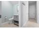 A half bathroom featuring a light blue wall and a gray vanity and toilet at 1719 Kenilworth St, Sarasota, FL 34231