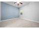 Neutral bedroom with carpet, a window, and a light blue accent wall at 1719 Kenilworth St, Sarasota, FL 34231