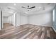 Large room with tray ceiling, fan, wood floors, and access to other rooms at 1719 Kenilworth St, Sarasota, FL 34231