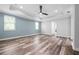 Spacious bedroom showcasing tray ceiling, fan, light blue accent wall, and wood flooring at 1719 Kenilworth St, Sarasota, FL 34231