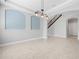 Bright dining area with staircase featuring neutral paint, decorative lighting, and large windows at 1719 Kenilworth St, Sarasota, FL 34231