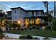 Elegant two-story home with lush landscaping and warm exterior lighting at twilight at 1719 Kenilworth St, Sarasota, FL 34231
