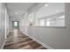 Hallway featuring arched openings and wood-look flooring, leading to rooms with ample natural light at 1719 Kenilworth St, Sarasota, FL 34231