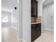 Hallway featuring tile flooring, cabinetry, and views into other rooms at 1719 Kenilworth St, Sarasota, FL 34231