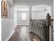 Hallway featuring arched entryways, wood floors, and decorative railing at 1719 Kenilworth St, Sarasota, FL 34231
