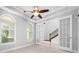 Home office featuring a ceiling fan, crown molding, natural lighting, and tiled floors at 1719 Kenilworth St, Sarasota, FL 34231