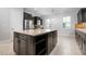 Open kitchen with island features granite countertops, stainless steel appliances, and dark cabinetry at 1719 Kenilworth St, Sarasota, FL 34231