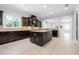 Open kitchen with island features granite countertops, stainless steel appliances, and mosaic backsplash at 1719 Kenilworth St, Sarasota, FL 34231