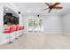 Open living room with tile flooring, ceiling fan, and access to outdoor space at 1719 Kenilworth St, Sarasota, FL 34231