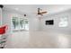 Spacious living room featuring tile flooring, ceiling fan, and sliding doors to the outside at 1719 Kenilworth St, Sarasota, FL 34231