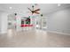 Inviting living area with open layout, ceiling fan, tile floors, and kitchen view at 1719 Kenilworth St, Sarasota, FL 34231