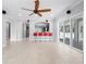 Spacious living room with tile floors, ceiling fan, and seamless access to the outdoors at 1719 Kenilworth St, Sarasota, FL 34231