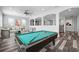 Open living space featuring decorative wall cut-outs, recessed lights, a pool table, and wood-look floors at 1719 Kenilworth St, Sarasota, FL 34231