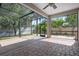 Screened-in patio with brick pavers, offering a seamless transition to the lush backyard at 1719 Kenilworth St, Sarasota, FL 34231